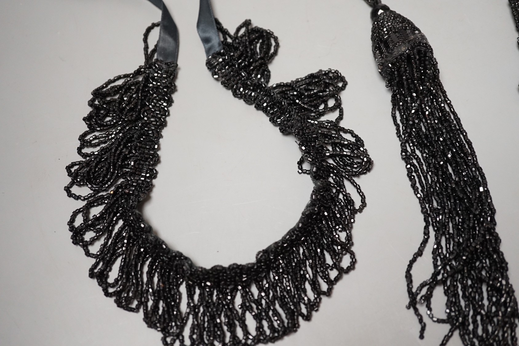Four assorted French jet necklaces, largest approx. 104cm.
